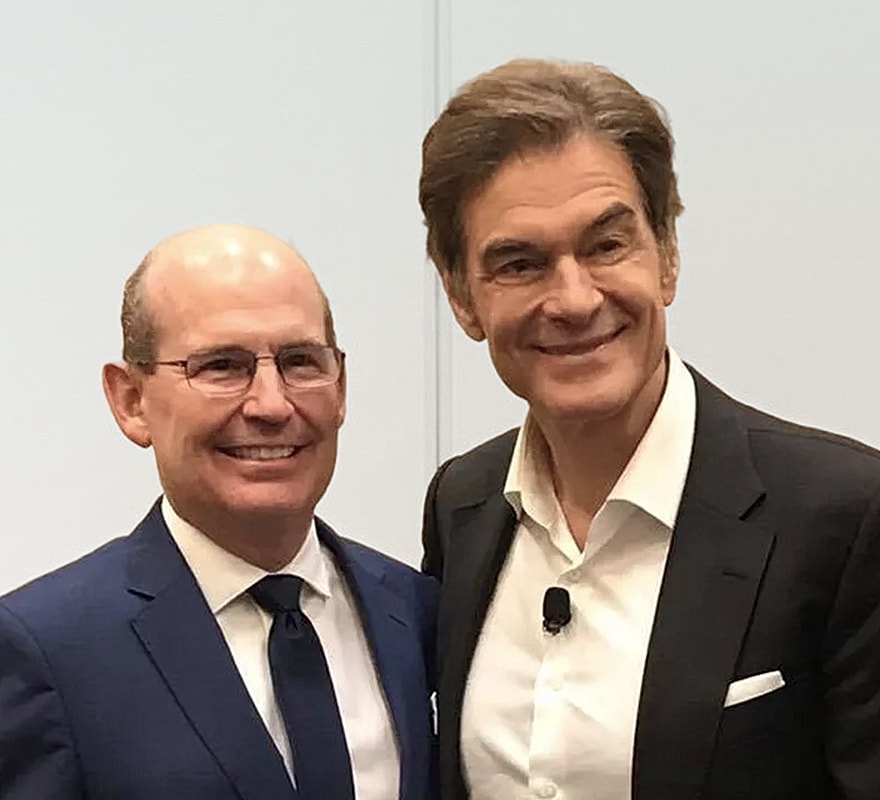 Two men smiling together at an event.