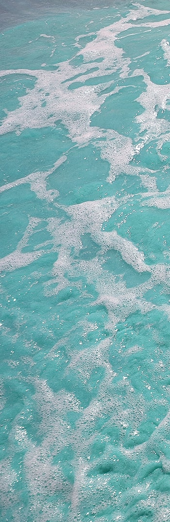 Turquoise ocean water with white foamy waves