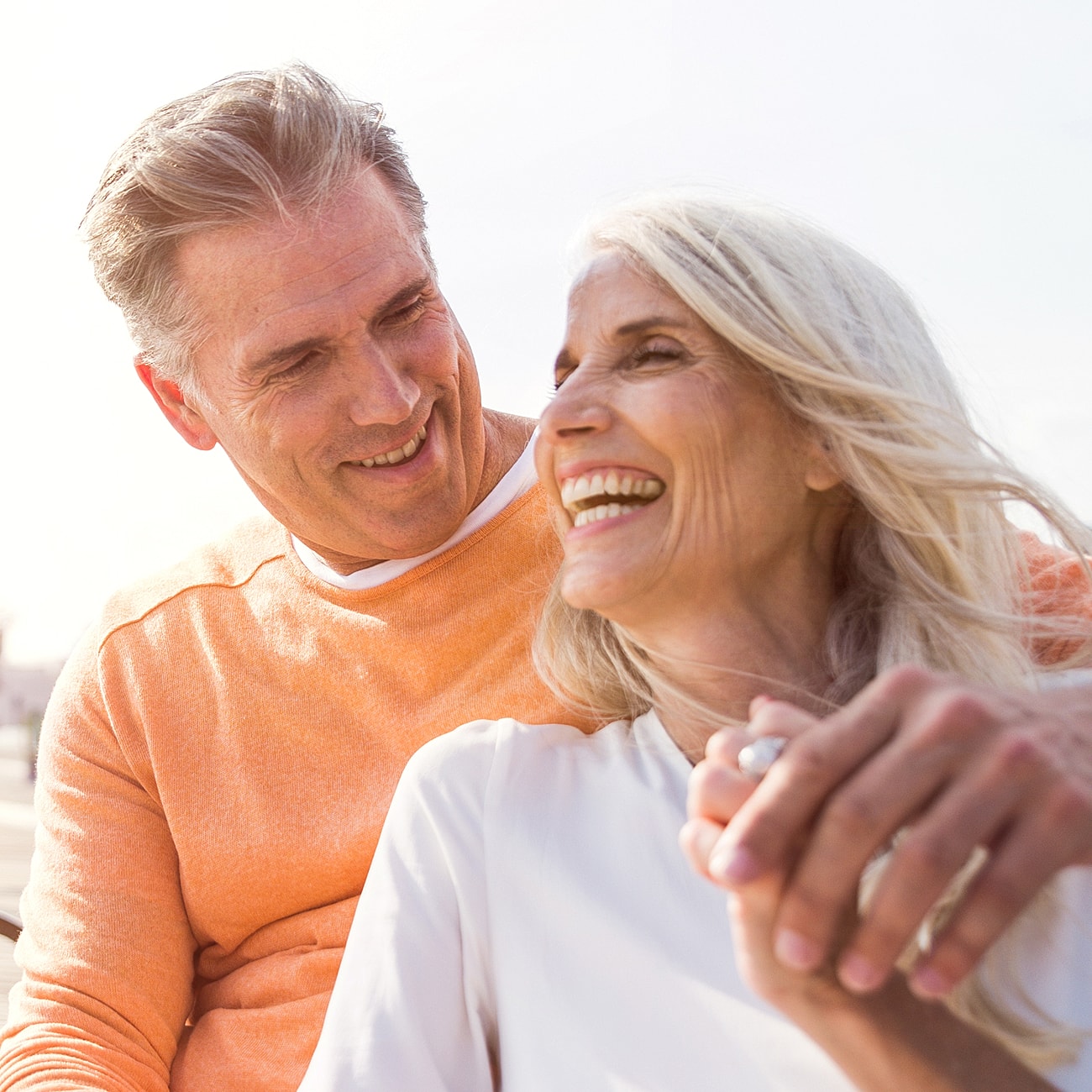 Couple enjoying a joyful moment together outdoors.